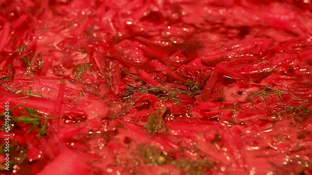 Cooking at home. Macro surface of borscht in a saucepan. The red beetroot soup starts to boil in the pot. Steaming Cooking at home. Macro surface of borscht in a saucepan. The red beetroot soup starts to boil in the pot. Steaming