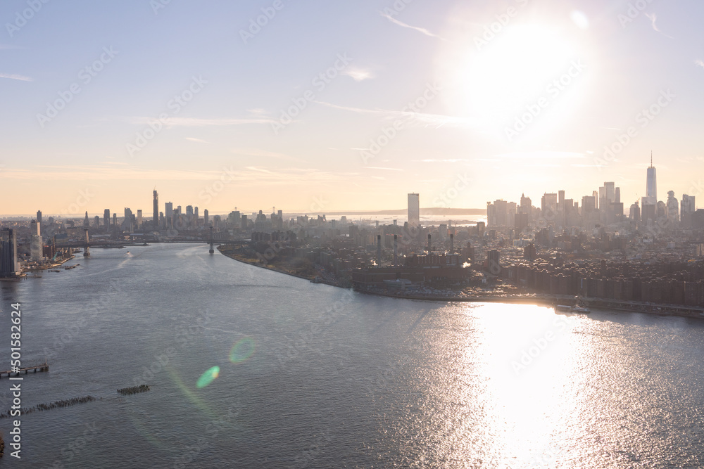 Fototapeta premium Aerial View of the Manhattan Skyline Between Brooklyn along the East River in New York City during a Sunset