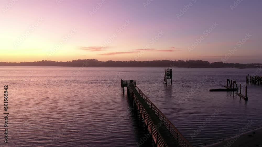 Empire Dock Jetty in Coos Bay at the Oregon Coast Trail. Vibrant sunset drone orbit. Empire Dock Jetty in Coos Bay at the Oregon Coast Trail. Vibrant sunset drone orbit.