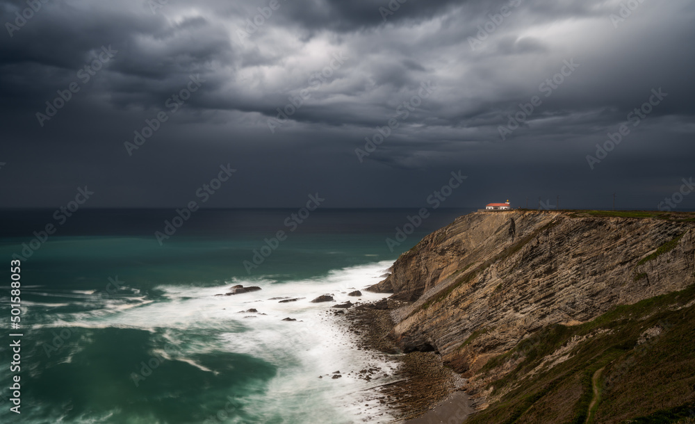 view of the lighthouse on the cliffs at Cabo Vidio under an overcast and stormy sky