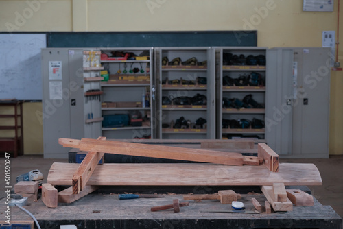 Senior male woodworker making console table  in workshop. Joinery work on the production  of wooden furniture. Small Business Concept