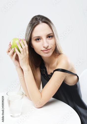 Wallpaper Mural lifestyle, health and people concept - young woman wearing pajamas holding a green apple Torontodigital.ca