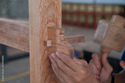 Obraz na płótnie Senior male woodworker making console table in workshop. Joinery work on the production of wooden furniture. Small Business Concept w salonie
