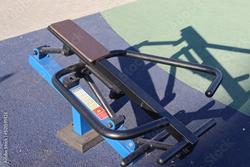 trainers and horizontal bars in city yard