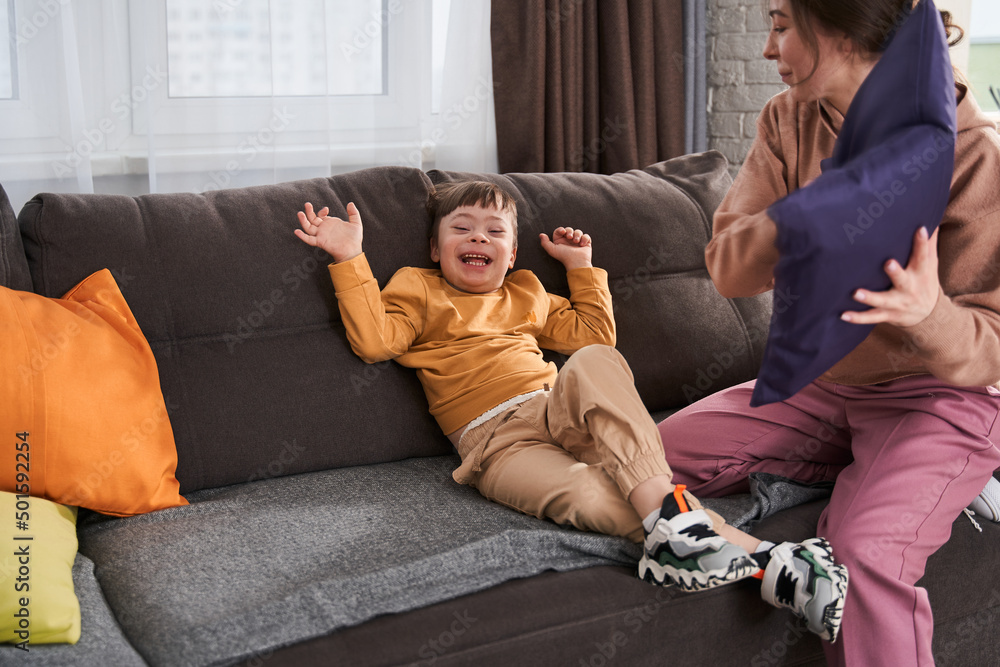 Overjoyed little boy with genetic disorder laughing out loud while playing Overjoyed little boy with genetic disorder laughing out loud while playing