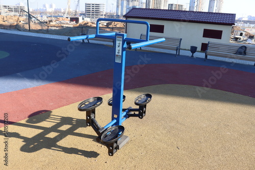 trainers and horizontal bars in city yard