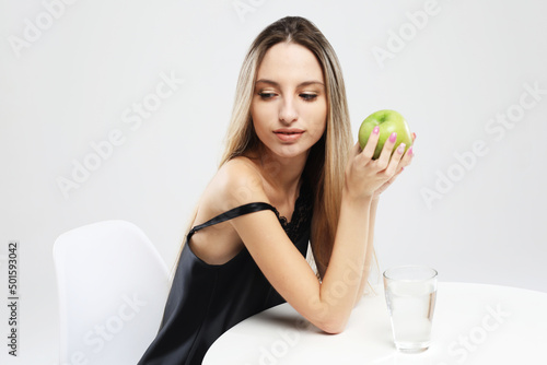 Wallpaper Mural lifestyle, health and people concept - young woman wearing pajamas holding a green apple Torontodigital.ca