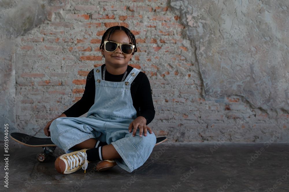 Little African kid boy with dreadlock hairstyle wear cool gold