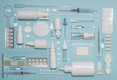 Layout of medicines and medicines. Pharmacy products of white shades on a blue background.