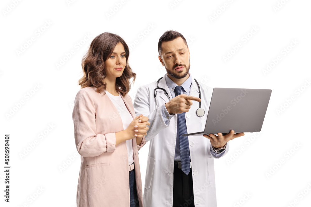 Doctor pointing at a laptop computer and standing with a young female patient Doctor pointing at a laptop computer and standing with a young female patient