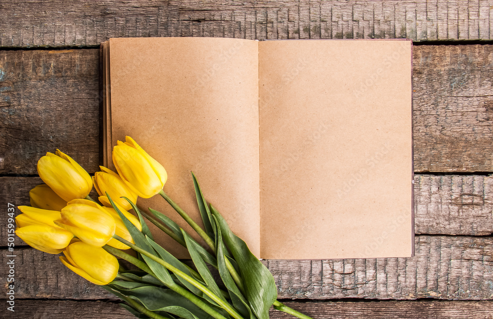 Open blank book and tulips