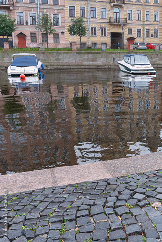 view from the embankment to small boats parked on the Griboyedov Canal in St. Petersburg, Russia