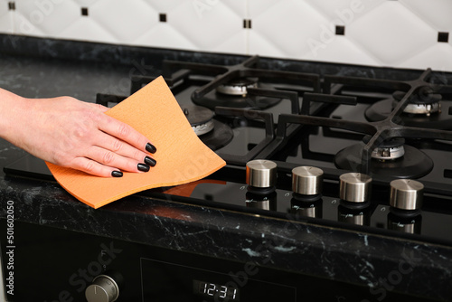 Konstfotografi Woman cleaning stove  at home