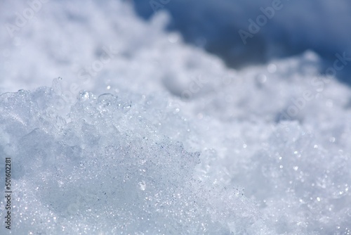 Snow crystalline background close-up. White with blue.