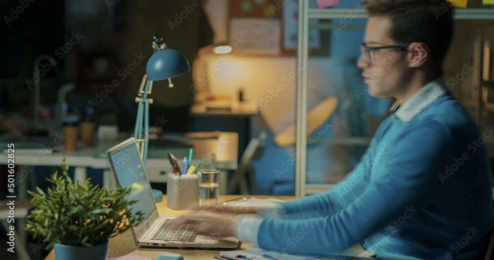 Time lapse of motivated businessman working in office all night using laptop then sleeping at desk. People and professional occupation concept.