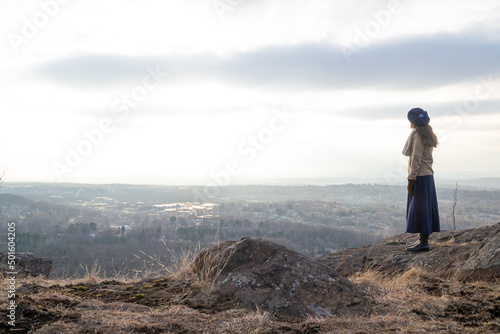 Woman standing at mountain overlook