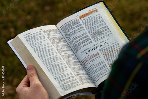 Closeup of open Bible in hands photo