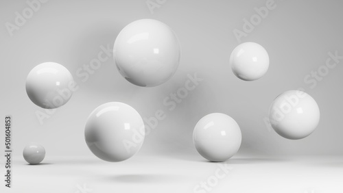 White spheres hang in weightlessness and stand on the floor. White uniform background. © Mikalai