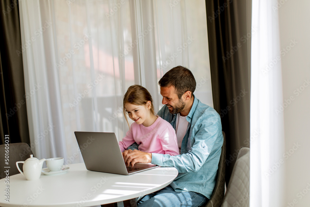 Father and daughter using laptop computer together Father and daughter using laptop computer together