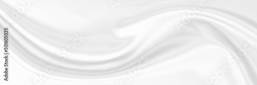 White gray satin texture that is white silver fabric silk panorama background with beautiful soft blur pattern natural.