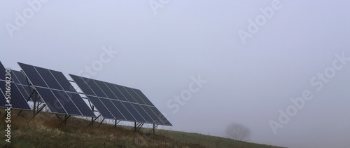 Solar panels, on a background of fog, spring morning. Spring, fog, energy. The concept of alternative, ecological energy.