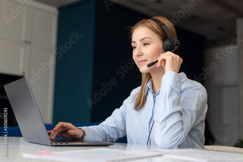 Woman using headset and laptop to work from home