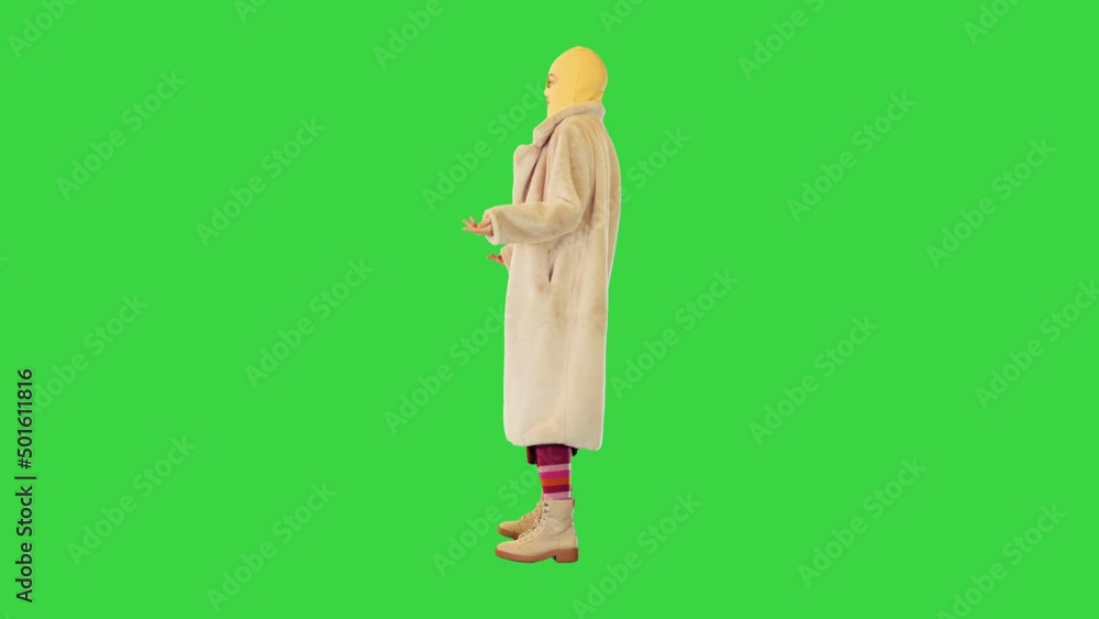 Girl in fur coat and balaclava dancing slightly on a Green Screen, Chroma Key. Girl in fur coat and balaclava dancing slightly on a Green Screen, Chroma Key.