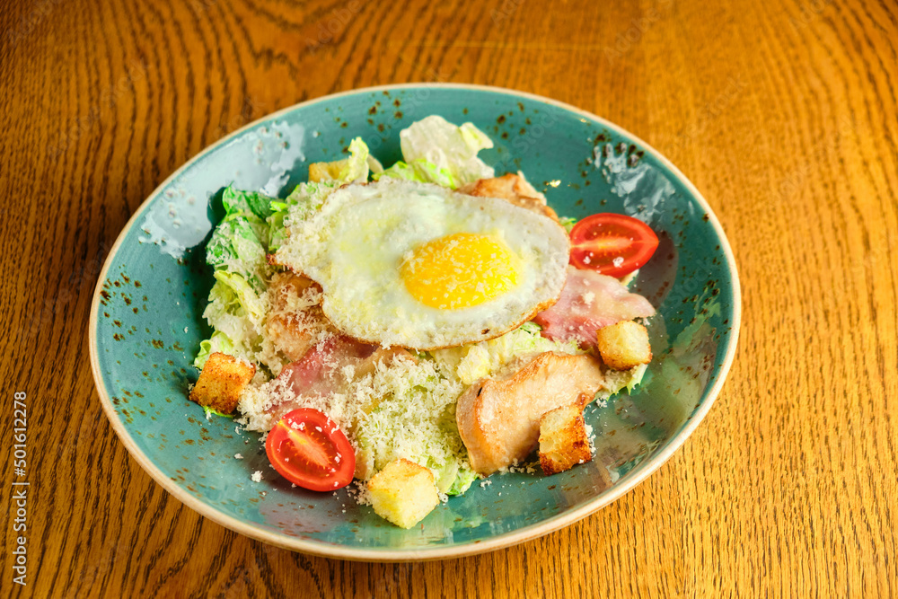 Caesar salad with large fried eggs Caesar salad with large fried eggs