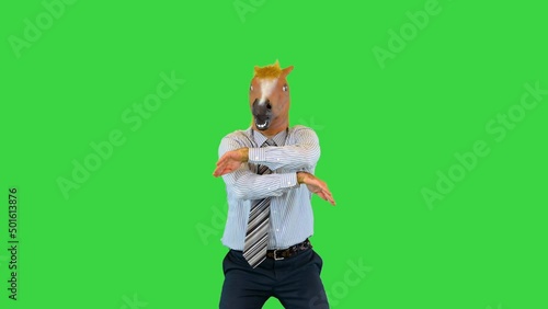 Crazy comic businessman or office worker wear horse mask in office perform funny dances at workplace on a Green Screen, Chroma Key.