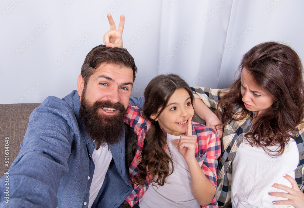 friendly family having fun. funny parents with kid girl at home. mom dad and daughter friendly family having fun. funny parents with kid girl at home. mom dad and daughter