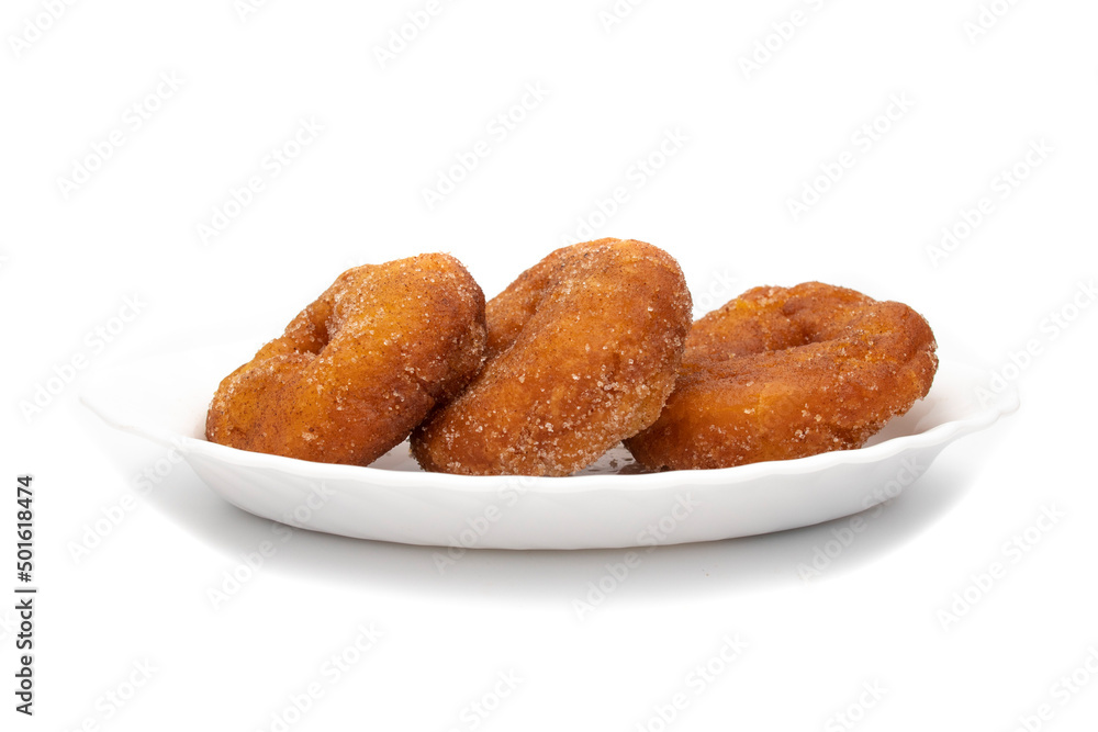 Three Spanish Donuts(Rosquillas) on a white plate, isolated on white background. The donut is a typical Spanish Easter sweet, whose origin dates back to the ancient Roman Empire.