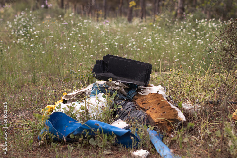 Garbage in nature, in a pine forest. Domestic pollution is becoming more serious, with an overpopulation. Garbage in nature, in a pine forest. Domestic pollution is becoming more serious, with an overpopulation.