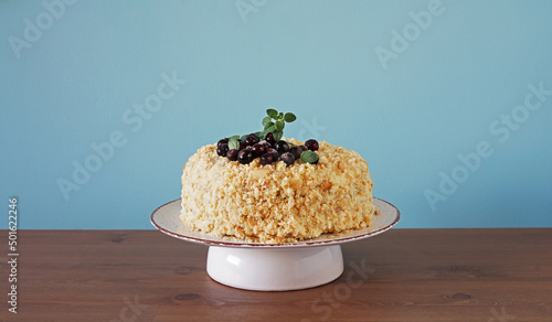 Homemade Layer Blackcurrant Jam Cake on the plate on blue background, copy space