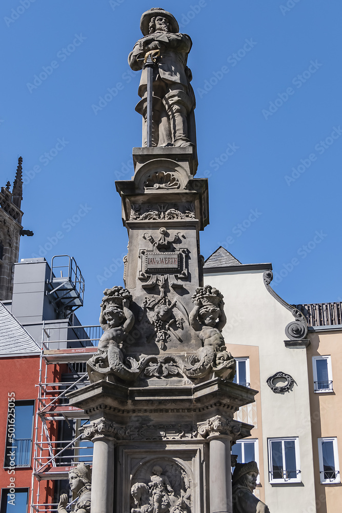 Stone statue of Jan van Werth (1884) on a gothic column. The seated figures on north and south side represent valor and purity of city of Cologne. Alte Markt, Cologne, North Rhine Westphalia, Germany.