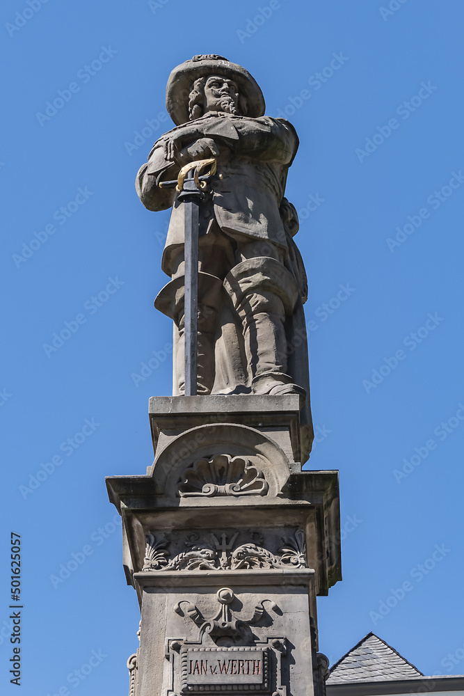 Stone statue of Jan van Werth (1884) on a gothic column. The seated figures on north and south side represent valor and purity of city of Cologne. Alte Markt, Cologne, North Rhine Westphalia, Germany. Stone statue of Jan van Werth (1884) on a gothic column. The seated figures on north and south side represent valor and purity of city of Cologne. Alte Markt, Cologne, North Rhine Westphalia, Germany.