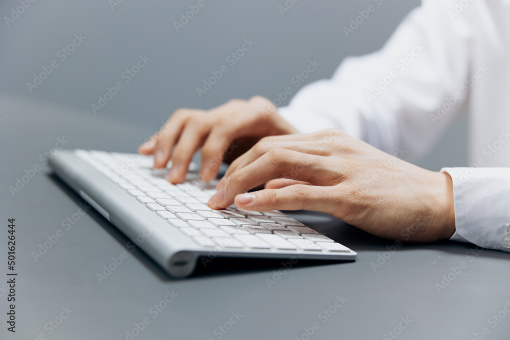 businessmen hands on keyboard office work close-up Gray background businessmen hands on keyboard office work close-up Gray background