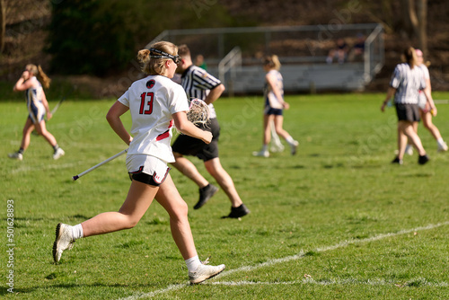 SEWICKLEY, PA, USA - APRIL13th 2022: Teenage girls from Sewickley Academy play senior school varsity lacrosse game against Freeport High School. There were lots of goals and action on this sunny day.