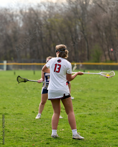 SEWICKLEY, PA, USA - APRIL13th 2022: Teenage girls from Sewickley Academy play senior school varsity lacrosse game against Freeport High School. There were lots of goals and action on this sunny day.