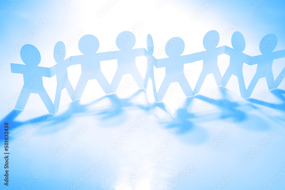 Team of paper chain people united together holding hands Team of paper chain people united together holding hands
