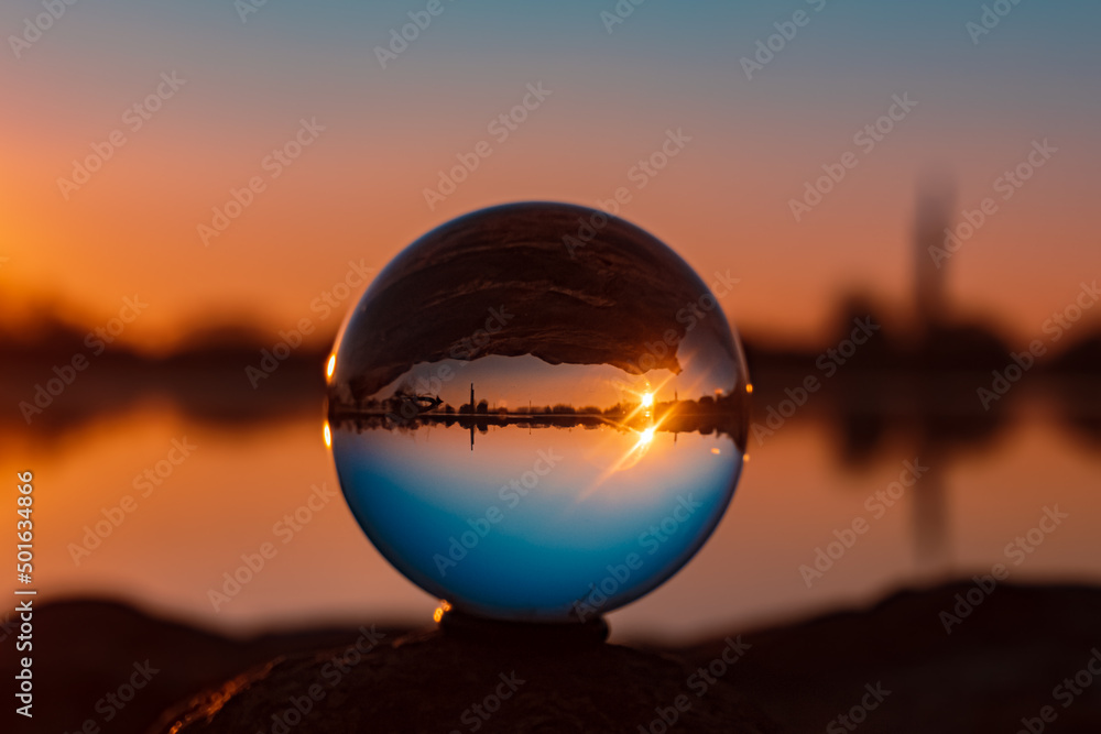 Obraz premium Crystal ball sunset shot with reflections at Pleinting, Danube, Bavaria, Germany