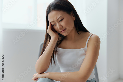 Panic attack. Upset tormented tanned beautiful young Asian woman touching head feel headache at home interior living room. Injuries Poor health Illness concept. Cool offer Banner Free Download Panic attack. Upset tormented tanned beautiful young Asian woman touching head feel headache at home interior living room. Injuries Poor health Illness concept. Cool offer Banner - GFXLoad