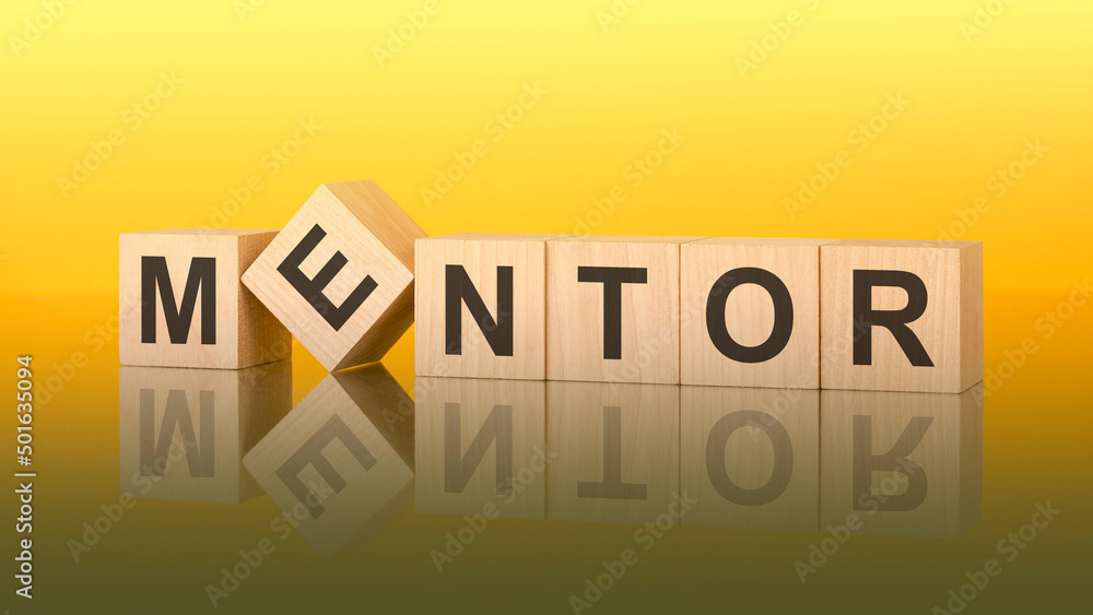 Obraz premium mentor word is made of wooden blocks lying on the yellow table, concept