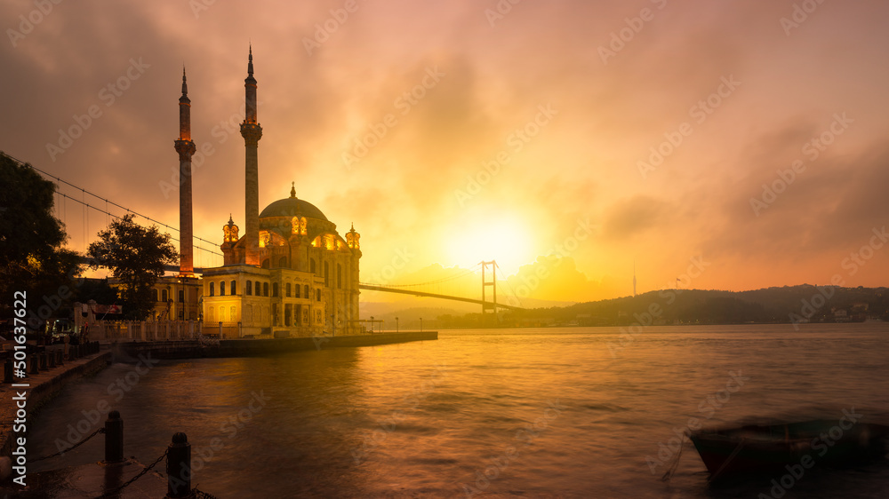 A beautiful sunrise at Ortakoy mosque and Bosphorus bridge. Ortakoy is one of the most popular touristic places in Istanbul. Sunrise scene in Istanbul. 