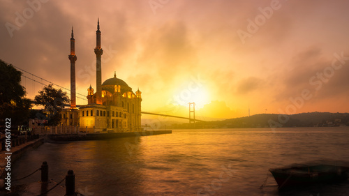 Fotografiet A beautiful sunrise at Ortakoy mosque and Bosphorus bridge