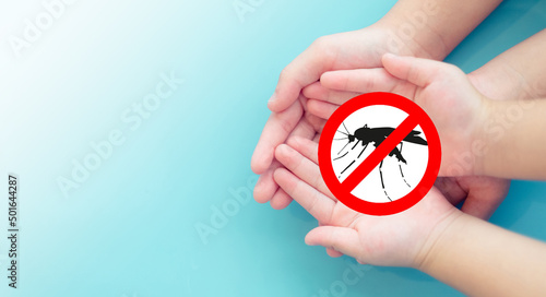 World malaria day.Kid hand and Mother with stop sign Mosquito blood breeding on kids.Repellent, Dengue virus, Yellow fever, Malaria vaccine Mosquitoes concept.Lotion and Spray repellent.Skin allergy. photo