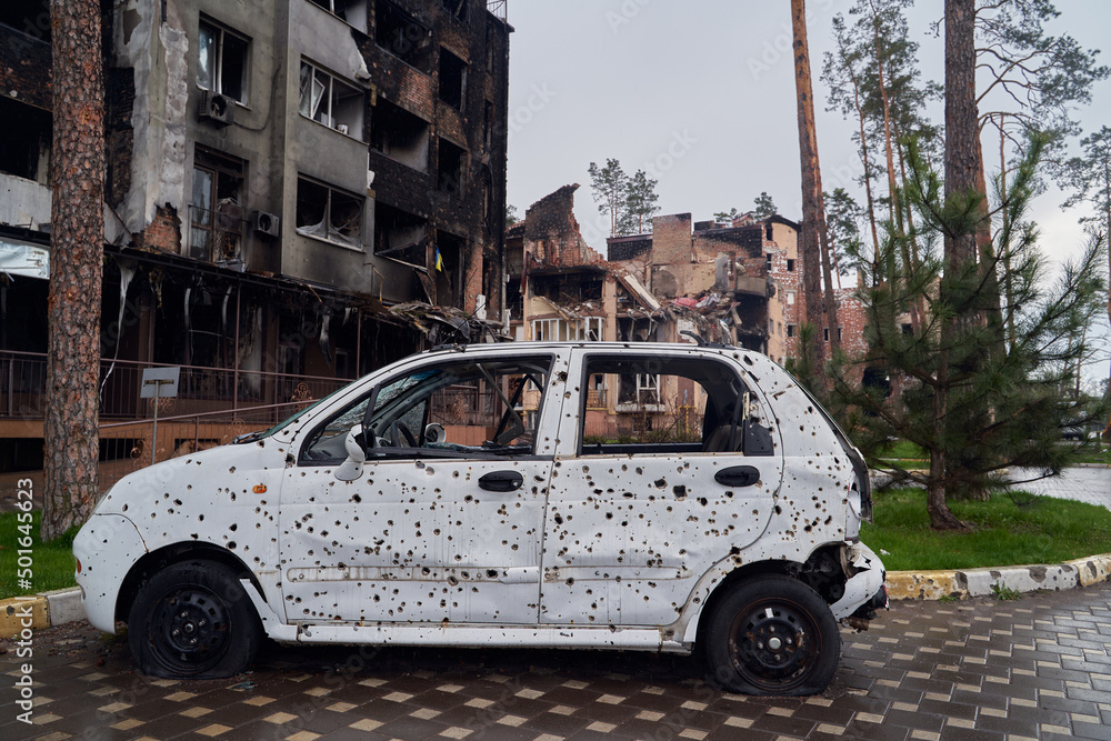 2022 Russian invasion of Ukraine war. War ruins city damage car. Terror attack bomb shell of civilian bombed. Disaster area. cars beaten by shrapnel and burnt