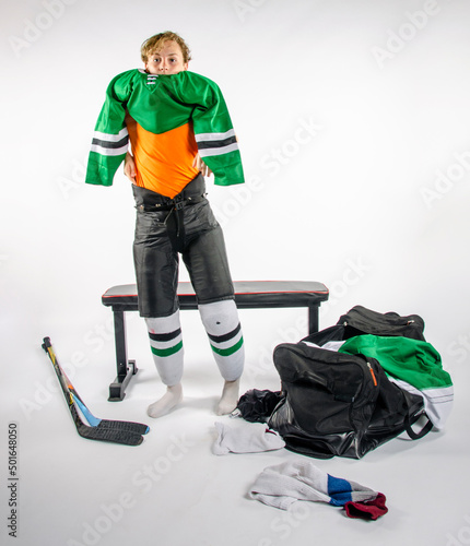 Canvas Print Male youth hockey player getting dressed for a game