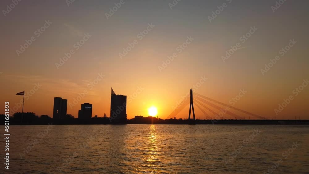 Sunset with the silhouette of the Vanšu Bridge in Riga, Latvia Sunset with the silhouette of the Vanšu Bridge in Riga, Latvia