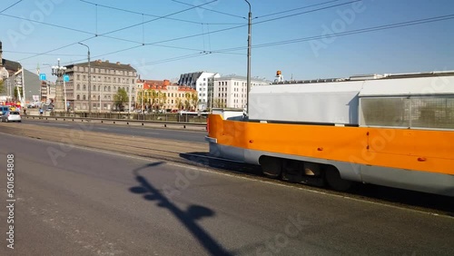 A cleaning tram washing the rails on the Stone Bridge, Riga photo