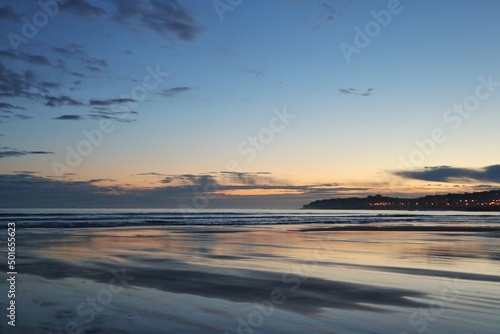 Reflejos del cielo sobre la arena mojada